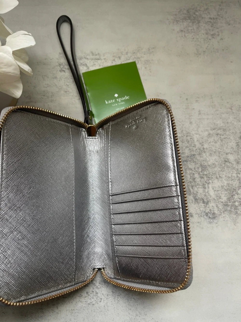 Kate Spade Laurie silver zip-around wristlet wallet